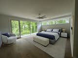 Main bedroom with private balcony overlooking tree-lined backyard