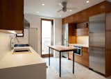 Kitchen, Engineered Quartz Counter, Wood Cabinet, Porcelain Tile Floor, Stone Slab Backsplashe, Recessed Lighting, Refrigerator, and Drop In Sink Kitchen  Photo 5 of 7 in Stuyvesant Townhouse by Rain Wang