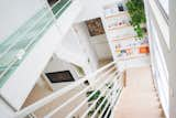 Staircase, Metal Railing, and Wood Tread the glass balcony on the upper level leads to three private rooms  Photo 9 of 12 in Villa delle Querce by Cafelab architects