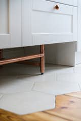 Kitchen, White Cabinet, Metal Cabinet, Medium Hardwood Floor, and Ceramic Tile Floor  Photo 5 of 21 in Apartment at Wilda by Mili Młodzi Ludzie 