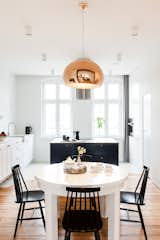 Dining Room, Pendant Lighting, Chair, Table, and Medium Hardwood Floor  Photo 15 of 21 in Apartment at Wilda by Mili Młodzi Ludzie 