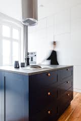 Kitchen, Colorful Cabinet, Granite Counter, Medium Hardwood Floor, Brick Backsplashe, Pendant Lighting, Wall Oven, Cooktops, and Drop In Sink  Photo 20 of 21 in Apartment at Wilda by Mili Młodzi Ludzie 