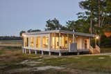 Exterior, Green Siding Material, Metal Siding Material, Prefab Building Type, Flat RoofLine, Wood Siding Material, Tile Roof Material, Mid-Century Building Type, and Green Roof Material Sunset shot  Photo 2 of 12 in The Beatty Home by Laurie Lauletta-Boshart 