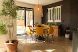 The cozy dining room features a circular table that accommodates the large family.  Another custom art piece by Boise artist Kate Crowley Gilbert hangs in the space.