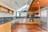 Kitchen, Medium Hardwood, Concrete, Wood, Concrete, Track, Ceiling, Refrigerator, Wall Oven, Range, Range Hood, Cooktops, Dishwasher, and Drop In Level 3 kitchen  Kitchen Wood Range Hood Concrete Medium Hardwood Photos from The Rempel Temple