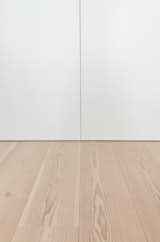 Custom White Lacquer Panels and White Ash Flooring Detail