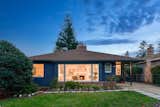 Classic 1952 home with a fresh coat of navy paint and large Bay window.