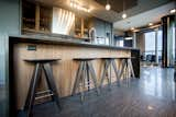 Kitchen, Engineered Quartz Counter, Pendant Lighting, Wood Cabinet, Ceiling Lighting, Glass Tile Backsplashe, and Ceramic Tile Floor  Photo 11 of 11 in Downtown Penthouse by Shaun Ford & Co. 