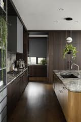 Kitchen, Refrigerator, Undermount Sink, Pendant Lighting, Quartzite Counter, Wood Cabinet, and Medium Hardwood Floor  Photo 6 of 18 in Lakeview House by Shaun Ford & Co. 