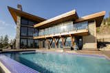 An infinity pool, spa, and spacious deck offer the space the homeowner needs to make the most of the Okanagan summer.