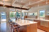 Kitchen, Wood Cabinet, Engineered Quartz Counter, Light Hardwood Floor, Ceiling Lighting, Pendant Lighting, Undermount Sink, Dishwasher, and Cooktops Kitchen with Appliance garage.   Photo 5 of 8 in San Juan Island Modular by Fish Mackay Architects