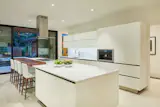 Custom kitchen by Ornare with sliding doors that open to the back patio and pool area.