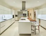 Custom kitchen by Ornare with custom wood accent on bar.