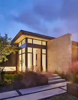 Entry featuring stone exterior and custom steel door.