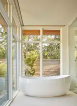 Master Bathroom featuring standing tub that overlooks the backyard and pool.