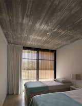 Bedroom, Bed, Ceiling Lighting, and Concrete Floor  Photo 13 of 31 in MARINDIA HOUSE by MASA Arquitectos