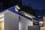 Exterior, House Building Type, Metal Roof Material, Wood Siding Material, Stucco Siding Material, and Gable RoofLine Night view.  Photo 15 of 15 in House in Ohue by DAISAKU HANAMOTO