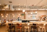 Dining Room, Bar, Stools, Chair, Ceiling Lighting, Pendant Lighting, Wall Lighting, Table, and Bench  Photo 1 of 6 in Vancouver’s Savio Volpe Is a Playful New Take on the Italian Osteria