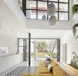Living Room, Sectional, Pendant Lighting, Concrete Floor, Storage, and Rug Floor  Photo 4 of 11 in Can This Renovated, Loft-Like Home in Spain Be Any Dreamier?