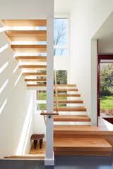 A modern staircase creates a visual connection to the woodland that surrounds the property.&nbsp;