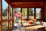 Off of the kitchen, the screened porch helps transition from the indoors to the outdoors, with the artist studio nearby.&nbsp;