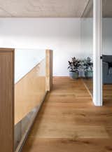 White oak flooring and accents throughout ground the airy space. 