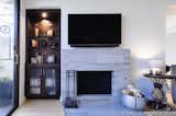 The outdated nook area was filled in with a functional chocolate brown entertainment unit and the open shelving creates a beautiful display area. The original fireplace was tiled over in a gray marble to modernize the space.

Interior Design, Photos & Styling © Yoko Oda Interior Design, LLC