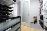 A 6'x 12' newly added walk-in closet for the master bedroom create more storage (even wine storage!) and a frosted glass door keeps the area light and airy. 

Interior Design, Photos & Styling © Yoko Oda Interior Design, LLC