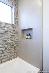A new modern tub and natural stone and glass tile mosaic backsplashes set the tone for the guest bath.
  
Interior Design, Photos & Styling © Yoko Oda Interior Design, LLC