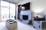 The outdated nook area was filled in with a functional chocolate brown entertainment unit and the open shelving creates a beautiful display area. The original fireplace was tiled over in a gray marble to modernize the space.

Interior Design, Photos & Styling © Yoko Oda Interior Design, LLC