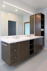 Custom designed teak vanity and storage cabinet with built-in laundry. 