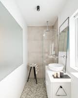 the Bathroom:  a tempered glass divides the kitchen and the bathroom space