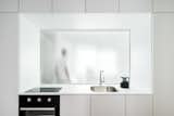  tempered glass – 113 CM high and 208 CM wide – the wall divides the kitchen and the bathroom space, while letting light from the bathroom window infiltrate into the cooking area.