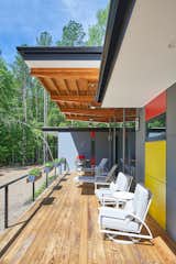 An 11' cantilevered roof shields the interior of the house from the hot summer sun, while providing a sheltered place to "sit outside when it rains" for the clients.