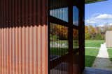 At entry, perforated Corten steel screenwall continues the north volume cladding and provides screen for covered spa.