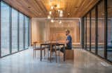 Dining Room, Table, Chair, Bench, Ceiling Lighting, Concrete Floor, and Light Hardwood Floor  Photo 7 of 20 in Northern Lake Home by Strand Design