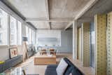Living Room, Sofa, Console Tables, Coffee Tables, Medium Hardwood Floor, and Floor Lighting  Photos from An Ingenious Gold Island Transforms an Industrial Apartment in Paris