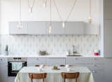 Kitchen, Ceramic Tile Backsplashe, Pendant Lighting, Drop In Sink, and Colorful Cabinet  Photo 12 of 17 in An Ingenious Gold Island Transforms an Industrial Apartment in Paris