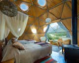 Bedroom, Chair, Pendant Lighting, Bed, Rug Floor, Medium Hardwood Floor, and Night Stands  Photo 4 of 13 in Soak Up the Magic of Patagonia at This Eco-Friendly Geodesic Dome Retreat