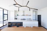 Dining Room, Pendant Lighting, Dark Hardwood Floor, Chair, and Table  Photos from Two Families Embrace Off-Grid Living in This Sustainable Prefab Home