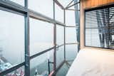 This top-level bedroom boasts spectacular views, thanks to the fully glazed walls and floor-to-ceiling windows.
