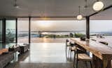 The open-plan dining and living area flow seamlessly into the outdoor terracotta terrace.