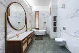 Bath, Wall, Drop In, Open, Freestanding, Marble, and One Piece A luxurious bathroom with marble walls and earthy timber elements.  Bath Freestanding Wall One Piece Photos from A Modern Home in India Evokes Emotion With a Giant 4-Ton Rock
