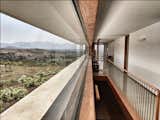 Windows, Picture Window Type, Wood, and Metal Large windows let in natural light and views from all directions.  Photos from A Modern Home in India Evokes Emotion With a Giant 4-Ton Rock