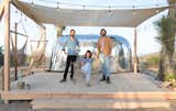 Exterior, Airstream Building Type, Metal Siding Material, Metal Roof Material, and Curved RoofLine Pictured from left to right: Andrew Uhlhorn, Justine Bennett, and Joseph August.  Photo 1 of 16 in Joshua Tree Is Now Home to a Chic Airstream Oasis—Featuring 4 Trailers Available to Rent