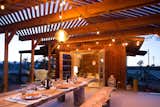 Dining Room, Table, Bench, and Pendant Lighting The Clubhouse also includes an outdoor shower powered by a solar hot-water tank, which was designed by their neighbor Dusty Devine.

  Photo 7 of 16 in Joshua Tree Is Now Home to a Chic Airstream Oasis—Featuring 4 Trailers Available to Rent