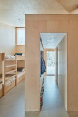 Bedroom, Recessed Lighting, Concrete Floor, and Bunks Each bedroom has two access doors, which close completely flush for a clean appearance.  Photo 9 of 14 in A Pinwheel-Shaped Cabin in Norway Is a Fresh Take on the Traditional Hytte