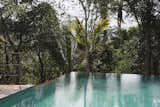 A nearly 50-foot-long infinity pool, also raised on stilts, overlooks views of the striking cardamon plantations. 