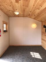 Living Room, Pendant Lighting, and Ceiling Lighting The interior of the prefab shed before renovations.   Photo 2 of 14 in A Couple Transform a Prefab Shed Into a Cozy Cabin in Less Than Two Months