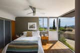 Bedroom, Ceiling Lighting, Medium Hardwood Floor, Bed, and Night Stands A floor-to-ceiling window in the master bedroom brings the outdoors in.   Photo 8 of 15 in Calling All Richard Neutra Fans—His Bonnet House in L.A. Hits the Market at $1.8M